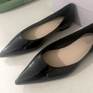 Black patent leather pointy flats.